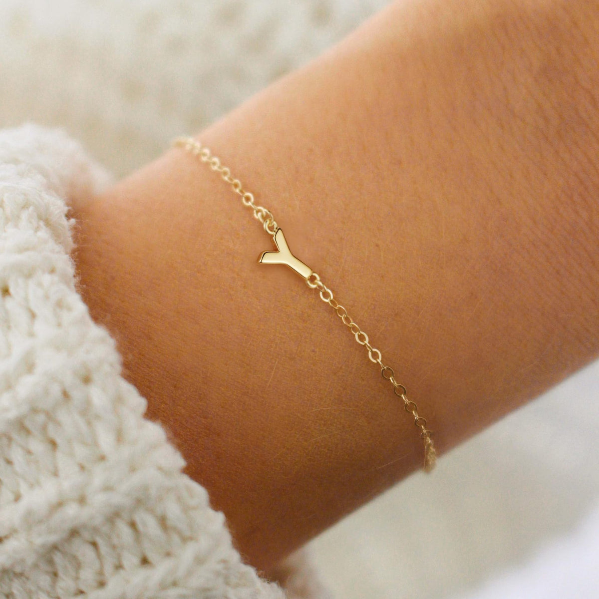 Gold initial Y bracelet at the wrist - Pulse and Glow
